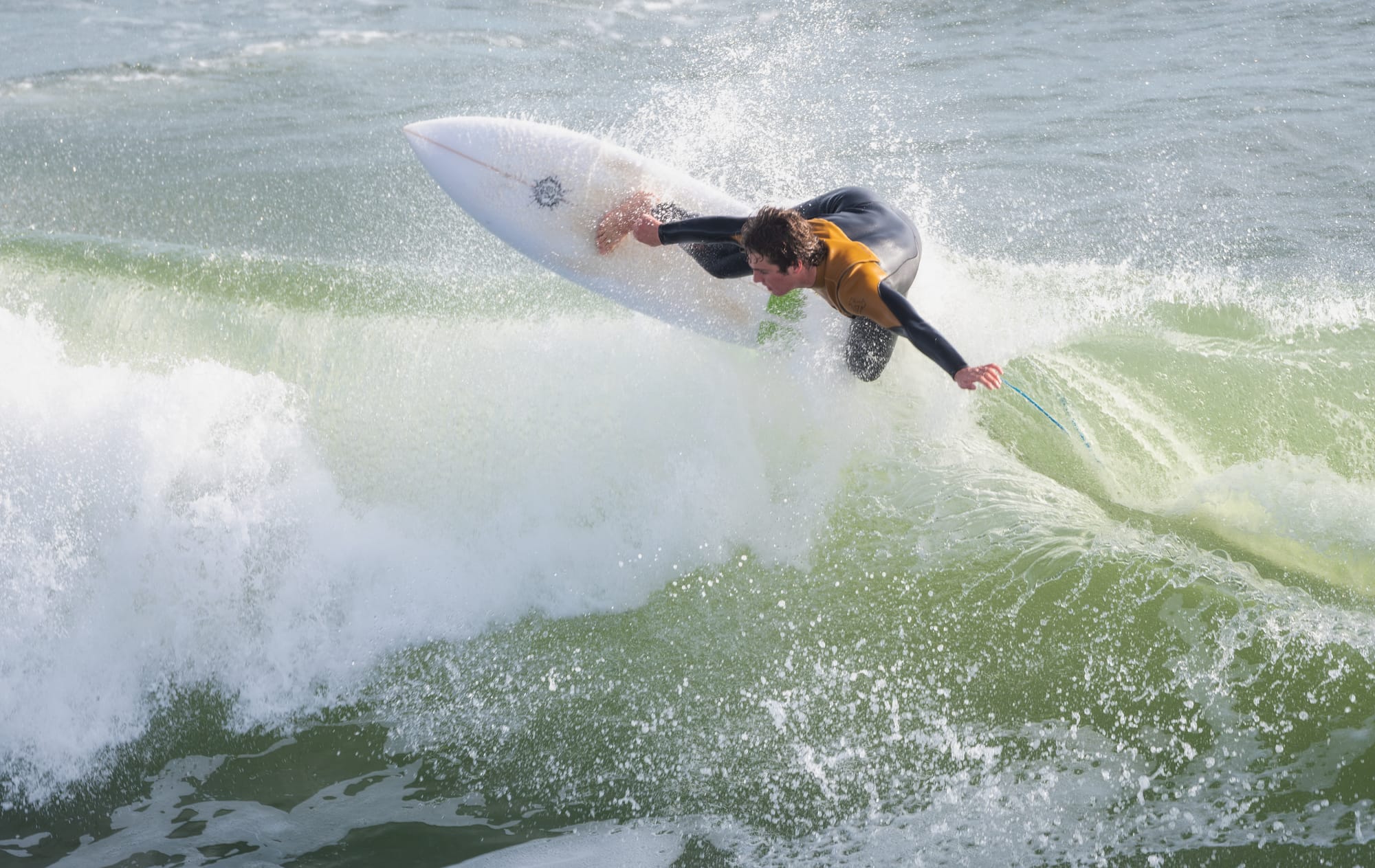 Surfer riding wave during California surf session demonstrating action photography timing